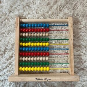 Melissa & Doug Wooden Abacus with Colorful Beads its has writing on it
